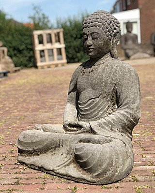 Buddha statue carved in Indonesian lavastone, seated, three-quarter left view