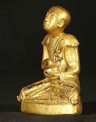 Burmese monk statue in lacquerware, seated, side profile view