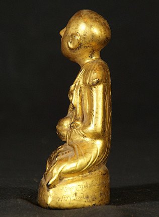 Antique Myanmar monk statue in lacquerware, left-side view with base edge