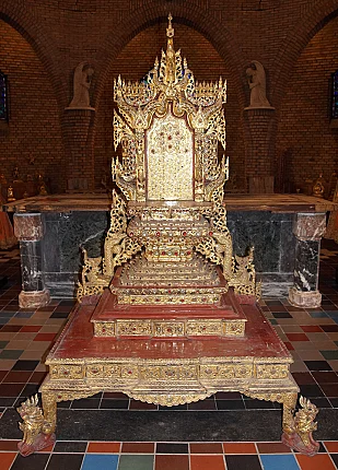 Large antique Burmese wooden throne from Myanmar, full front view with gilded carving