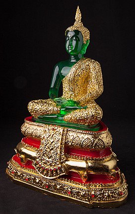 Thai Buddha statue seated, three-quarter view showing gold robe and red-gold pedestal base