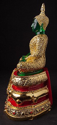 Thai Buddha statue seated, left side profile with gold robe and tiered red-gold base