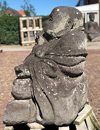 Lavastone Happy Buddha statue, seated side profile showing robe folds