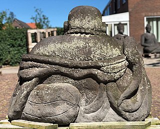 Seated lavastone Happy Buddha statue, rear view with broad back and robe edge