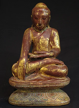 Antique wooden Buddha statue from Burma in bhumisparsha mudra, full front view