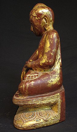 Sitting wooden Buddha statue from Burma, left side profile showing ear and base