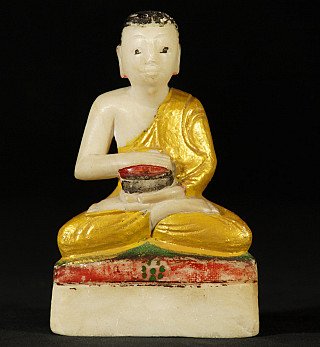 Burmese monk statue in marble, seated holding an alms bowl, full front view