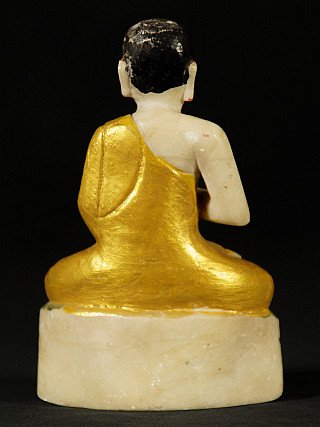 Burmese monk statue in marble, seated, rear view showing draped gilded robe