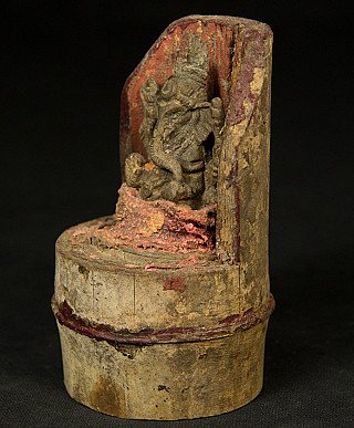 Bronze Ganesha statue from Nepal on bamboo, three-quarter view showing the side wall and red paint traces