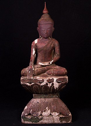 Wooden Buddha statue from Burma (Myanmar), seated, full-front view on tall base with worn paint