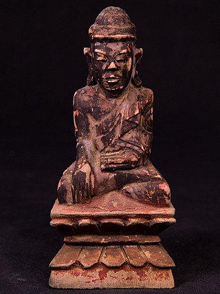 Burmese Shan Buddha statue in wood, seated front view with right hand reaching down