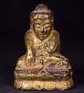 Antique Burmese Buddha statue in wood, seated on a lotus base, full-front view