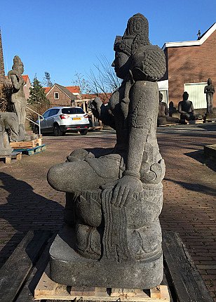 Devi Tara statue in Indonesian lavastone, seated side profile showing arm and leg