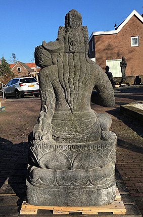 Rear view of the seated Devi Tara statue in Indonesian lavastone, showing long hair and back carving