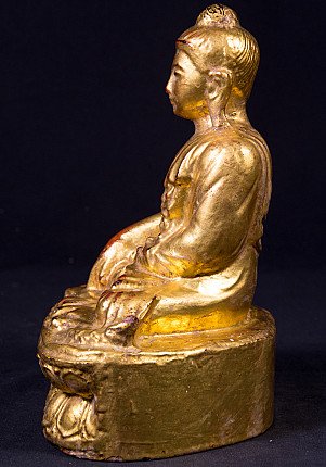 Gilded wooden Buddha statue from Burma, left side profile showing topknot and robe folds