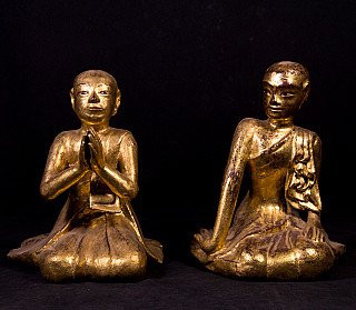 Two Burmese wooden monk statues, front view; left with namaskara mudra, right with hand on knee