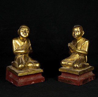 Pair of 19th-century wooden monk statues from Burma (Myanmar), seated with hands in prayer on red bases