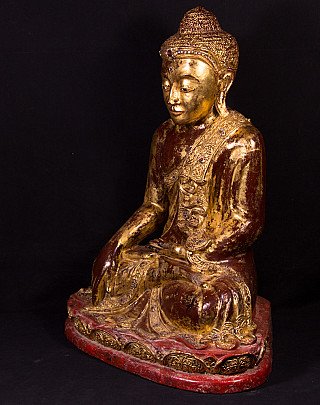 Wooden Buddha statue from Myanmar with gilded surface, three-quarter left view
