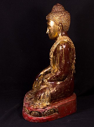 Wooden Mandalay Buddha statue from Burma, seated, left side profile with red base