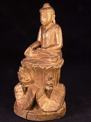 Buddha statue in wood from Myanmar, three-quarter left view showing varada mudra and robe