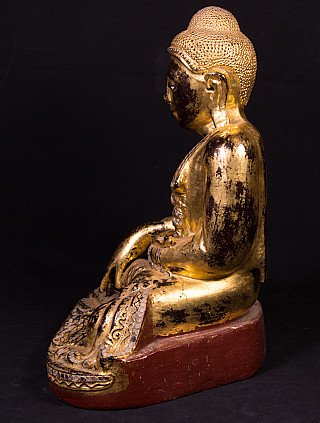 Burmese wooden Buddha statue, left side profile showing the seated posture