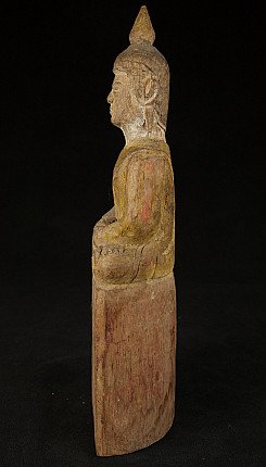 Thai wooden Buddha statue seated, left side profile showing the head and tall base