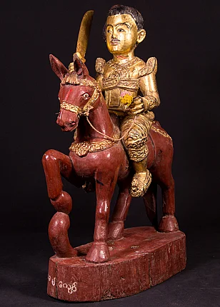 Burmese Nat statue on horseback in wood, three-quarter left view with raised sword