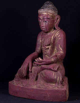 Burmese wooden Buddha statue seated in bhumisparsha mudra, three-quarter left view