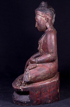 Wooden Buddha statue in Mandalay style, left side profile showing the ear and stepped base
