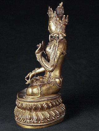 White Tara statue in Nepalese bronze, left side profile with crown and lotus stem