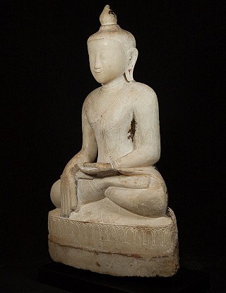 Marble Buddha statue from Myanmar, seated, three-quarter view showing hands and robe