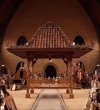Indonesian teak temple house, full front view with high roof and four corner posts
