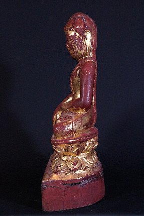 Antique wooden Buddha statue from Burma, left side profile in seated posture on lotus base