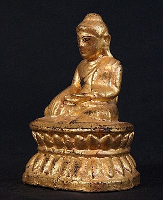 Wooden Buddha statue from Burma, seated on lotus base, three-quarter left view