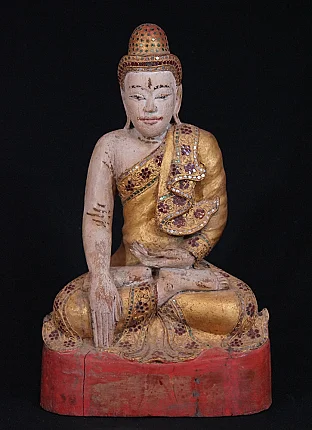 Burmese wooden Buddha statue in bhumisparsha mudra, full front view on red base