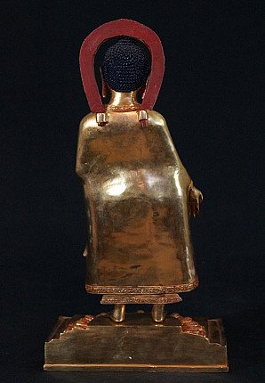Nepali bronze Buddha statue, rear view with plain robe and back of the halo