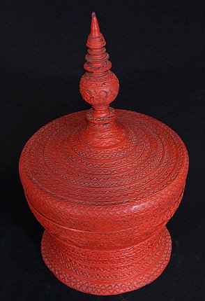 Burmese wooden offering vessel in red lacquer, three-quarter view emphasizing the lid