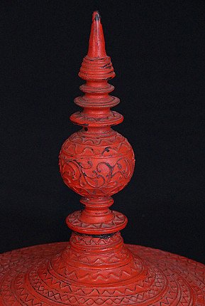 Detail of the turned finial on the red Burmese offering vessel lid