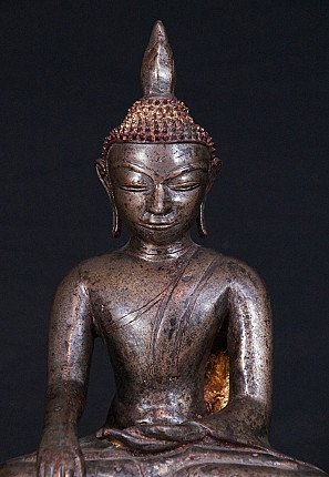 Front view detail of face and chest on the bronze Buddha statue from Myanmar