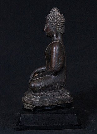 Thai bronze Buddha statue seated, left side profile view