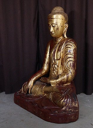 Buddha statue from Burma (Myanmar), wooden with gilt and red lacquer, three-quarter left view