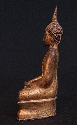 Thai bronze Buddha statue in left side profile, seated on base