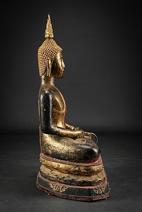 Burmese bronze Buddha statue with tall flame finial, left side profile view