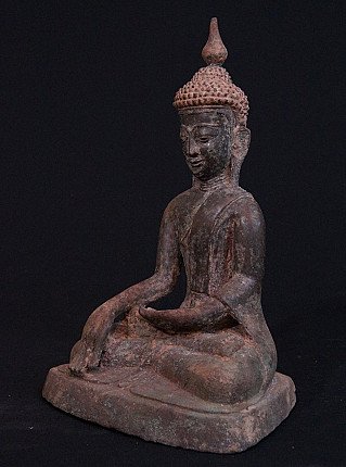 Antique Burmese Inwa Buddha statue in bronze, three-quarter view showing the earth-touching hand
