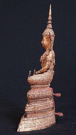 Thai bronze Buddha statue seated, side profile with tall headdress and stepped base